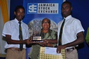 Mrs. Marlene Street Forrest, General Manager Jamaica Stock Exchange is flanked by first runner up Domar Blake (left) and the top student Lando Graham (right), both from St. Jago High School.